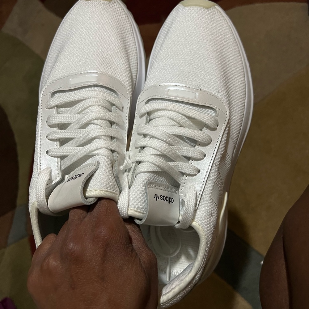 Woman’s white Adidas